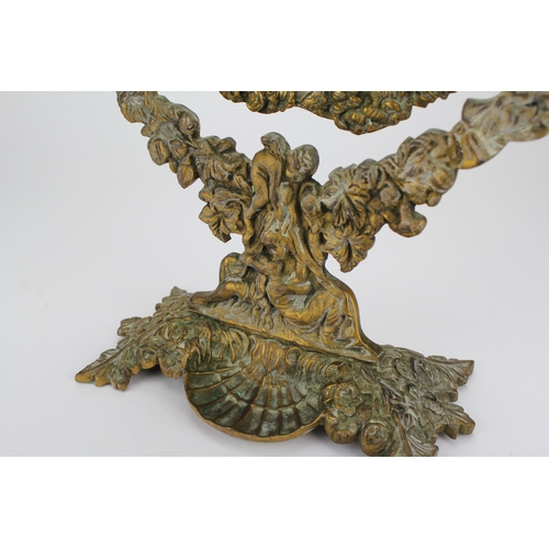 669 - A cast brass swing frame mirror decorated with flowers.