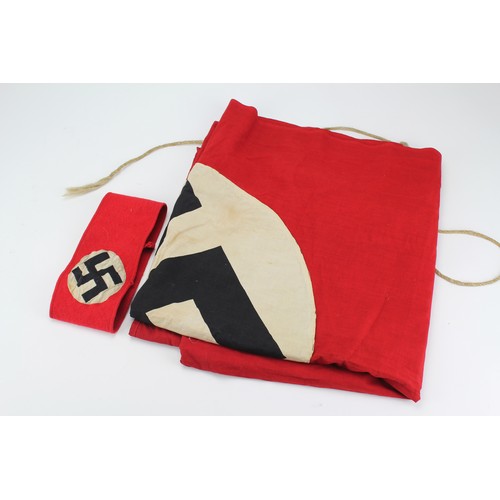 648 - A Nazi red and white circular linen flag, black printed swastika, along with a matching arm band.