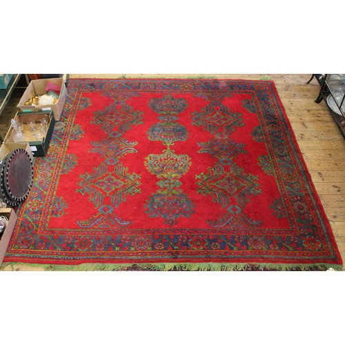 538 - A red ground floral decorated Doregel carpet in ushate style.