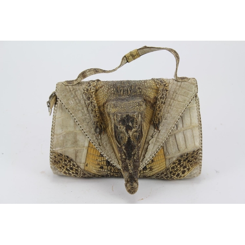 616 - A native made crocodile skin handbag, with a crocodile head.