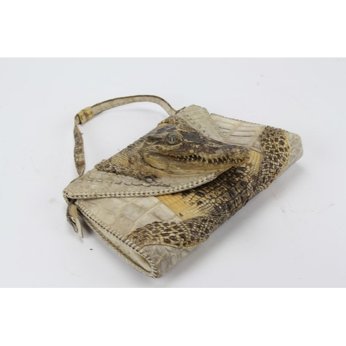 616 - A native made crocodile skin handbag, with a crocodile head.