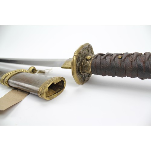 525 - A Japanese World War II Katana, in a steel and brass mounted sheath.