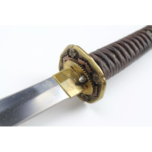 525 - A Japanese World War II Katana, in a steel and brass mounted sheath.