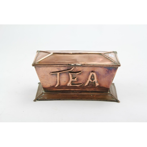 671 - An Arts & Crafts Copper embossed Tea Caddy of Sarcophagus form with raised lid & a Caddy Spoon.