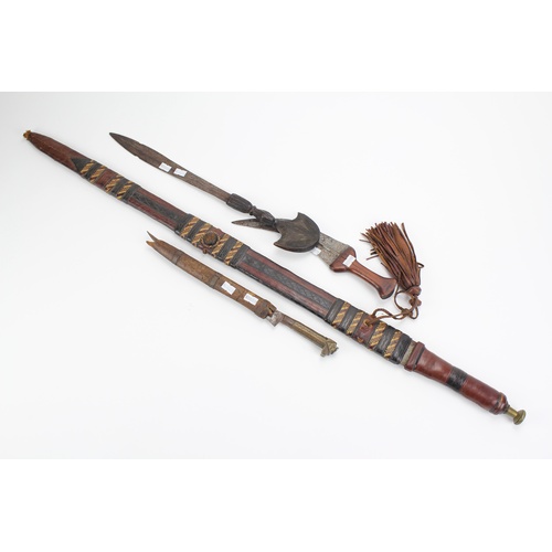 649 - A North African thrusting sword, in leather scabbard, with woven decoration, along with a tiger claw... 