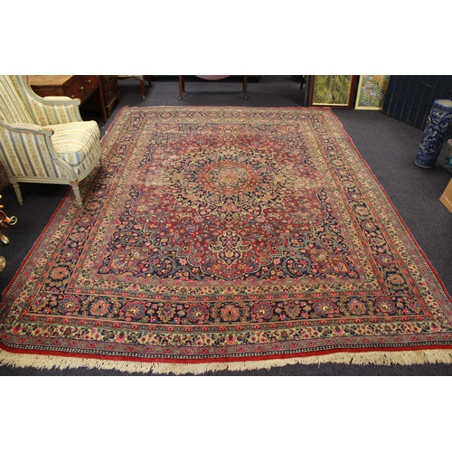 537 - An Antique Red and Blue Ground Persian carpet.