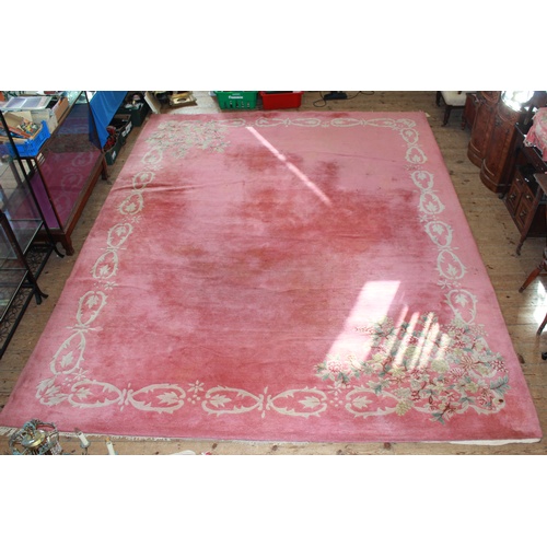 534 - A large Pink Floral Carpet decorated flowers  with fringe. Measures: 13Ft 4 inches x 10Ft 6 inches.