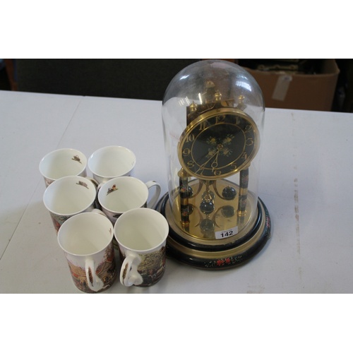 90 - A Clock with a glass dome with a set of six mugs.