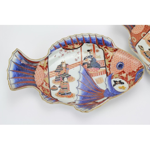 409 - A Pair of Japanese Imari Rust Blue Carp Shaped serving dishes decorated with samurai warriors & atte... 