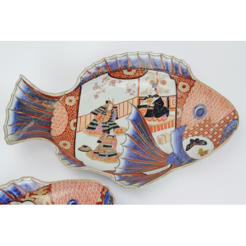 409 - A Pair of Japanese Imari Rust Blue Carp Shaped serving dishes decorated with samurai warriors & atte... 