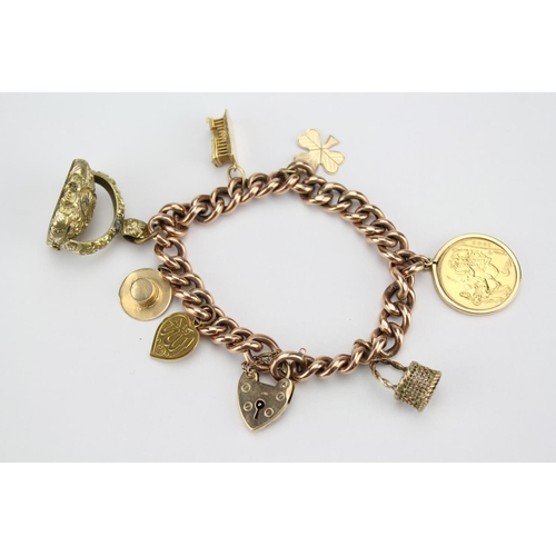 138 - A 1962 Gold Sovereign and other Charms on a Bracelet to include a basket, hat, 3 Leaf clover, ruins,... 