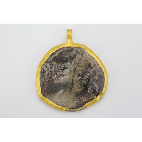 473 - A Roman Glass Pendant mounted in a Gilt Metal Frame.