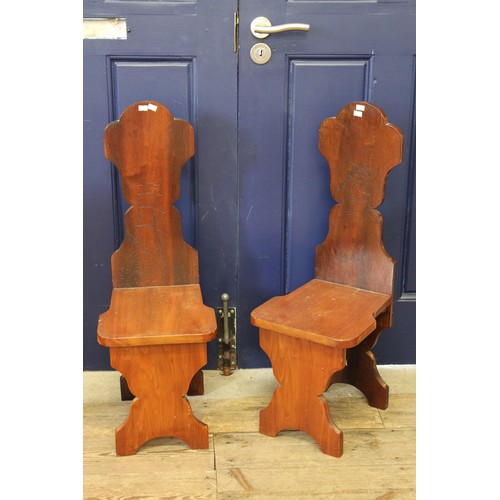 350 - A pair of shaped back hall chairs resting on shaped legs.