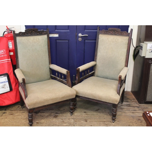 364 - A pair of Victorian ladies and gentleman open armed fire side chairs with carved backs & turned legs... 