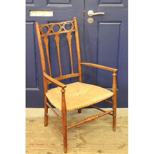 371 - A 1930's wicker arm chair with high back.