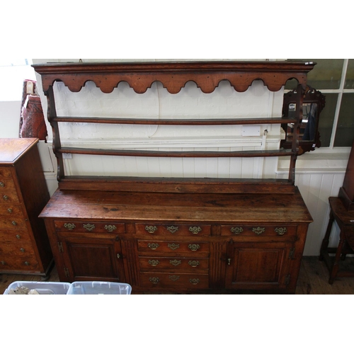 373C - An Antique Oak North Country dresser fitted with two end cupboards, a bank of three graduated drawer... 