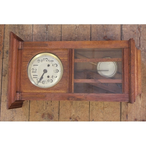 133 - A 1920's German made Wall Clock. Measuring: 25 inches high x 15 inches wide.