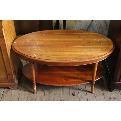 385 - An Oval Yew Wood Coffee Table Resting on Shaped Legs.