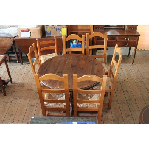 394 - A Stained Pine Circular Table and Six Similar Chairs & one other chair.