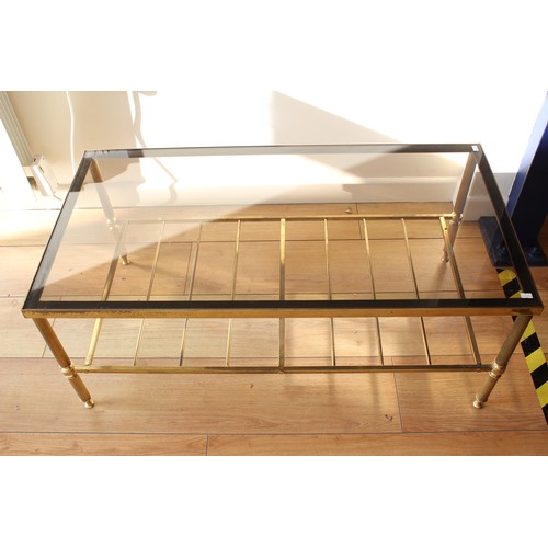 431 - A Glass Topped Coffee Table on a fluted brass stand.