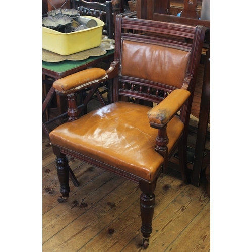 443 - A Victorian Mahogany Library Chair with turned front legs, Leather Pads, China Castors.