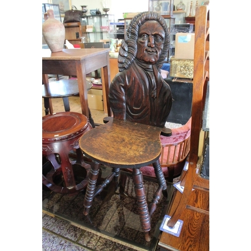 456 - A Late 19th Century Oak Carved Hall Chair decorated with carved relief of an 18th Century Gentleman ... 