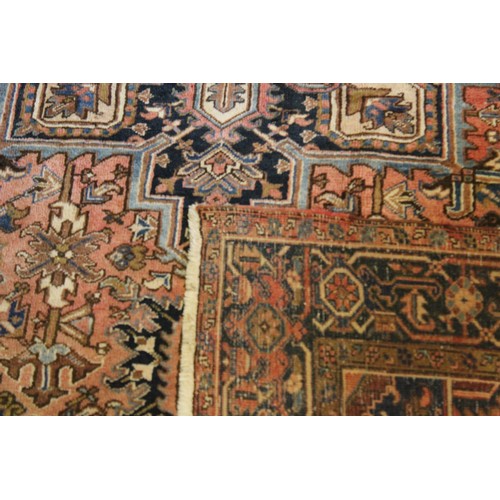 333 - An Antique Rust Blue floral bordered central medallion all over patterned Persian carpet. Measuring ... 