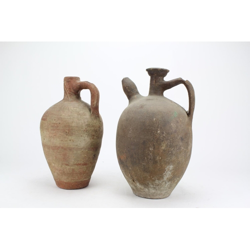 555 - Two Small Greek Terracotta Water or Oil Carriers one with incise, Loop Handles and Squat Nozzles..