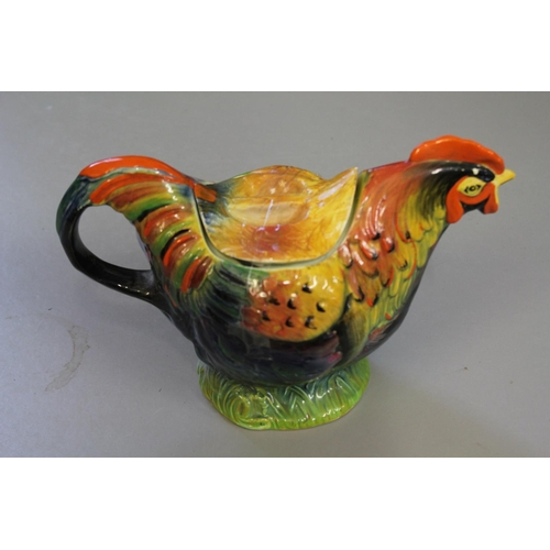 563 - A Rooster Tea Pot Decorated in Green, Brown and Blue, Registration No: 810175.