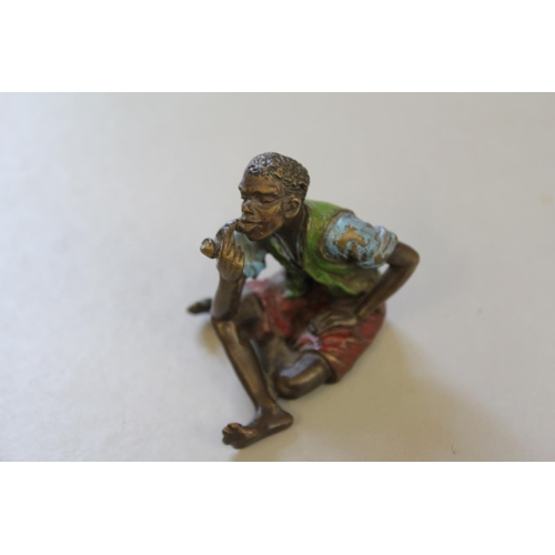 677 - A Bronzed Study of a Young Boy Smoking a Pipe.