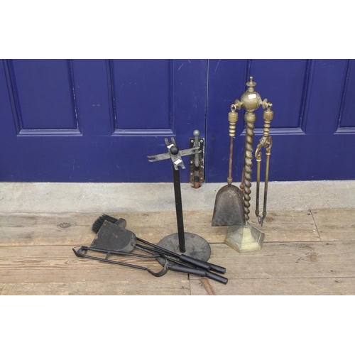 688 - A Brass Fire Side Stand & a similar one in wrought iron.