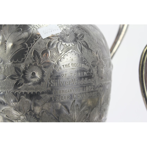 81 - A Silver Plated and Engraved Claret Jug and Electro Plated Tea Urn on Base.