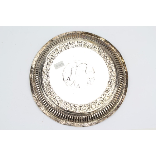 68 - An Indian Silver Floral Embossed Edged Salver Decorated with a Washer Woman. AF. Weighing 247 Grams.