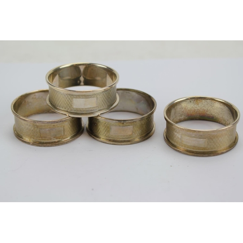 72 - A Set of Four Engine Turned Napkin Rings in Boxes.