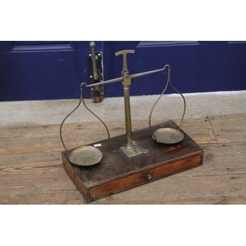 710 - A Set of Twin Pan Brass Scales on Mahogany Base Fitted Drawer.