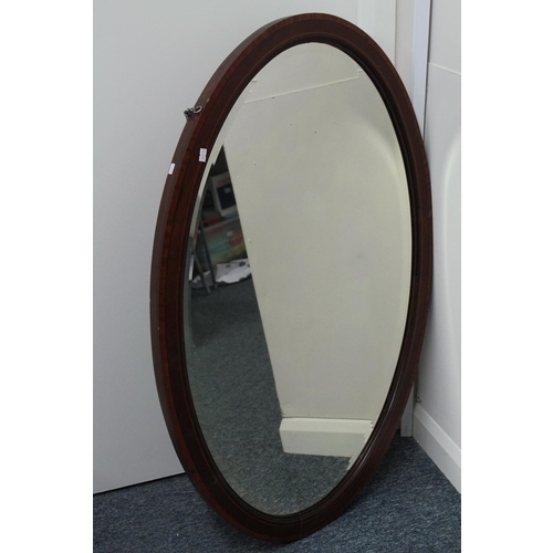 461 - An Edwardian Mahogany and satinwood inlaid oval framed bevelled mirror.