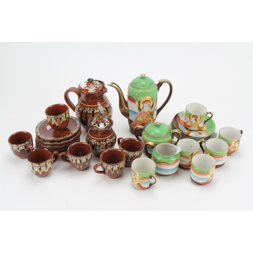 484 - A Swiss pottery Coffee service and a similar Japanese eggshell tea set decorated in green, rust and ... 