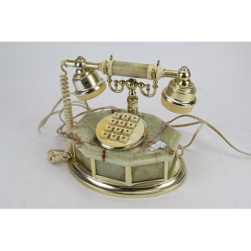 499 - An Onyx Mounted Telephone in Brass Effect.