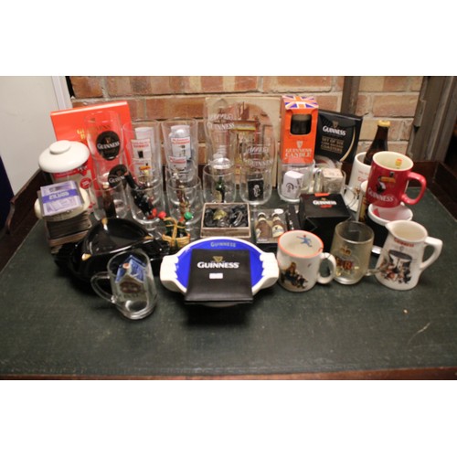 130 - A Collection of 50+ Guinness Memorabilia to include Glasses, Mugs, Ashtrays along with other boxed i... 