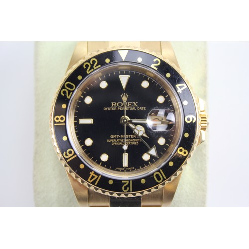 103 - A Rolex GMT-Master II in 18k Yellow Gold, Oyster Perpetual, Gents Wristwatch. Black dial with date a... 