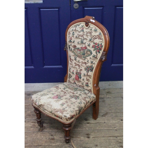 333 - A Victorian Mahogany framed nursing chair with carved Florett sides and resting on turned front legs... 