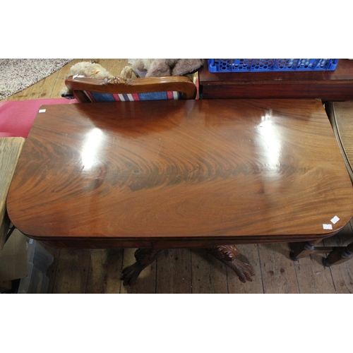 446 - A Victorian Flame Veneered Fold over Top Card Table resting on a heavily carved paw feet. Measuring:... 