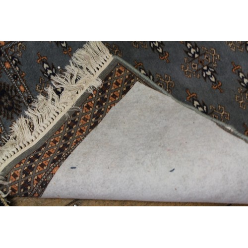 295 - A Blue and Beige carpet runner with white frill. Measuring: 330cms Long x 80cms Wide.