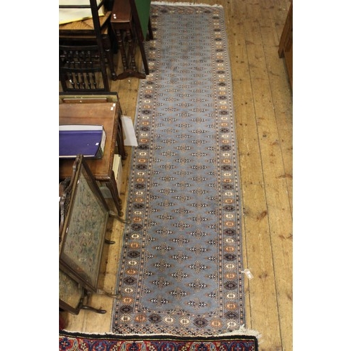 295 - A Blue and Beige carpet runner with white frill. Measuring: 330cms Long x 80cms Wide.