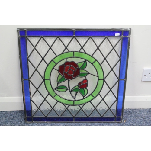 318 - A 1920s designed glass leaded panel from a door flower in a blue boarder 22inches square