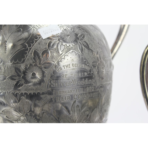 116 - A Silver Plated and Engraved Claret Jug and Electro Plated Tea Urn on Base.