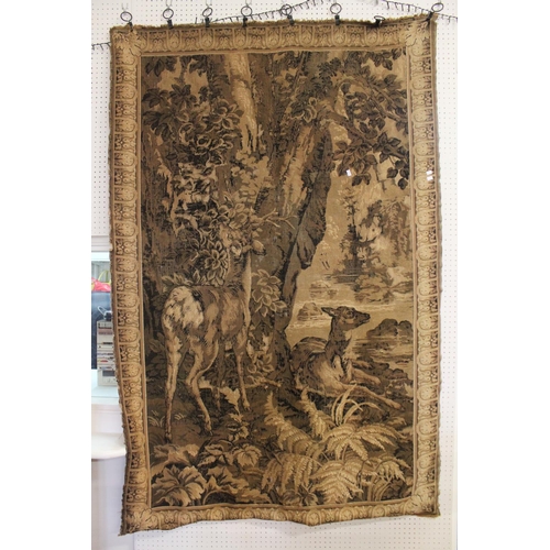 308 - A Flemish Tapestry of Deer resting by a lake with a floral edge and boarder. Measuring: 188cms x 121... 