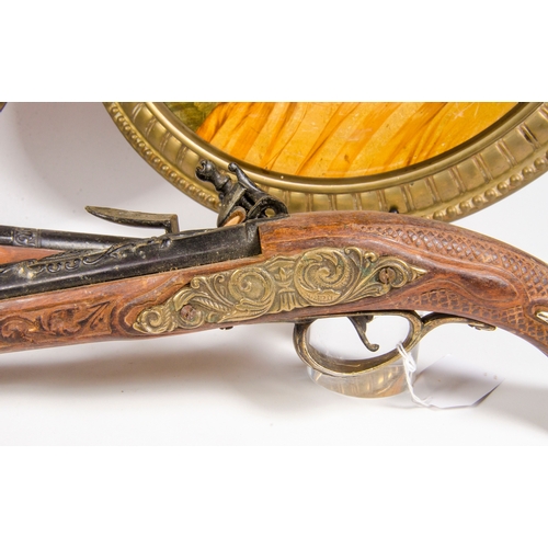 52 - A pair of reproduction flint lock pistols along with a pair of Art Nouveau pressed and decorated wal... 