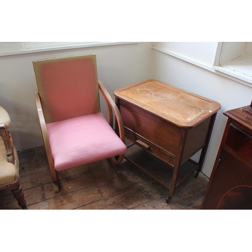 72 - A 1930's Woven fibre Cantilever bathroom chair and a 1950's oak needlework trolley.