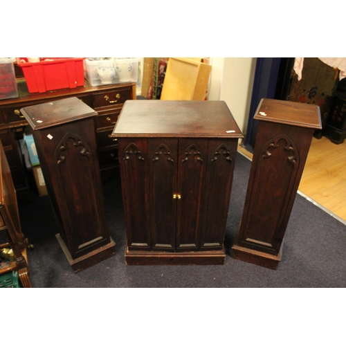 70 - A carved Oak Lincolnshire design T.V. Cabinet along with a pair of matching speaker cabinets.